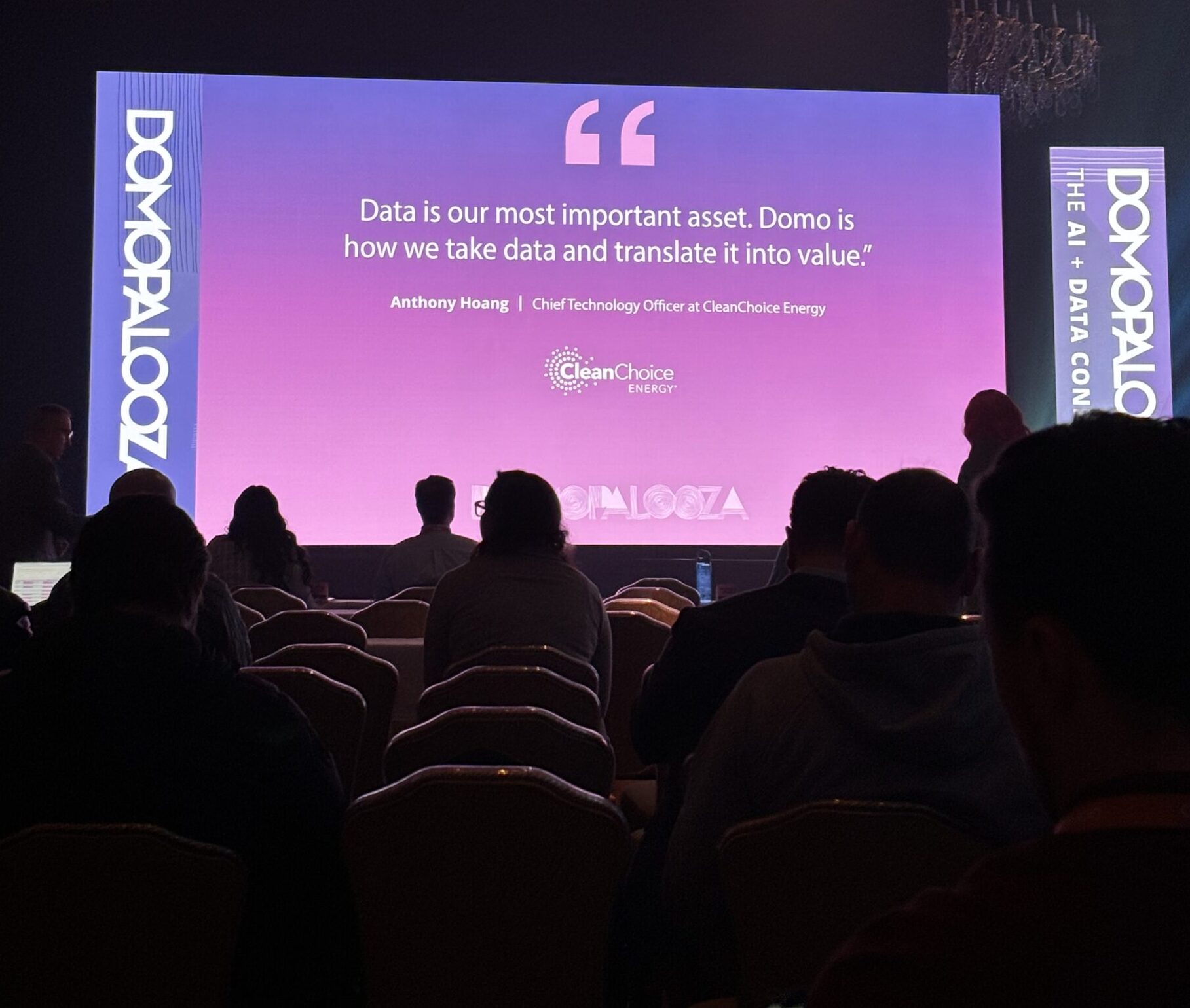 The image shows a slide from the Domopalooza 2024 Main Session with a quote from a Domo user that says "Data is our most important asset.  Domo is how we take data and translate it into value."